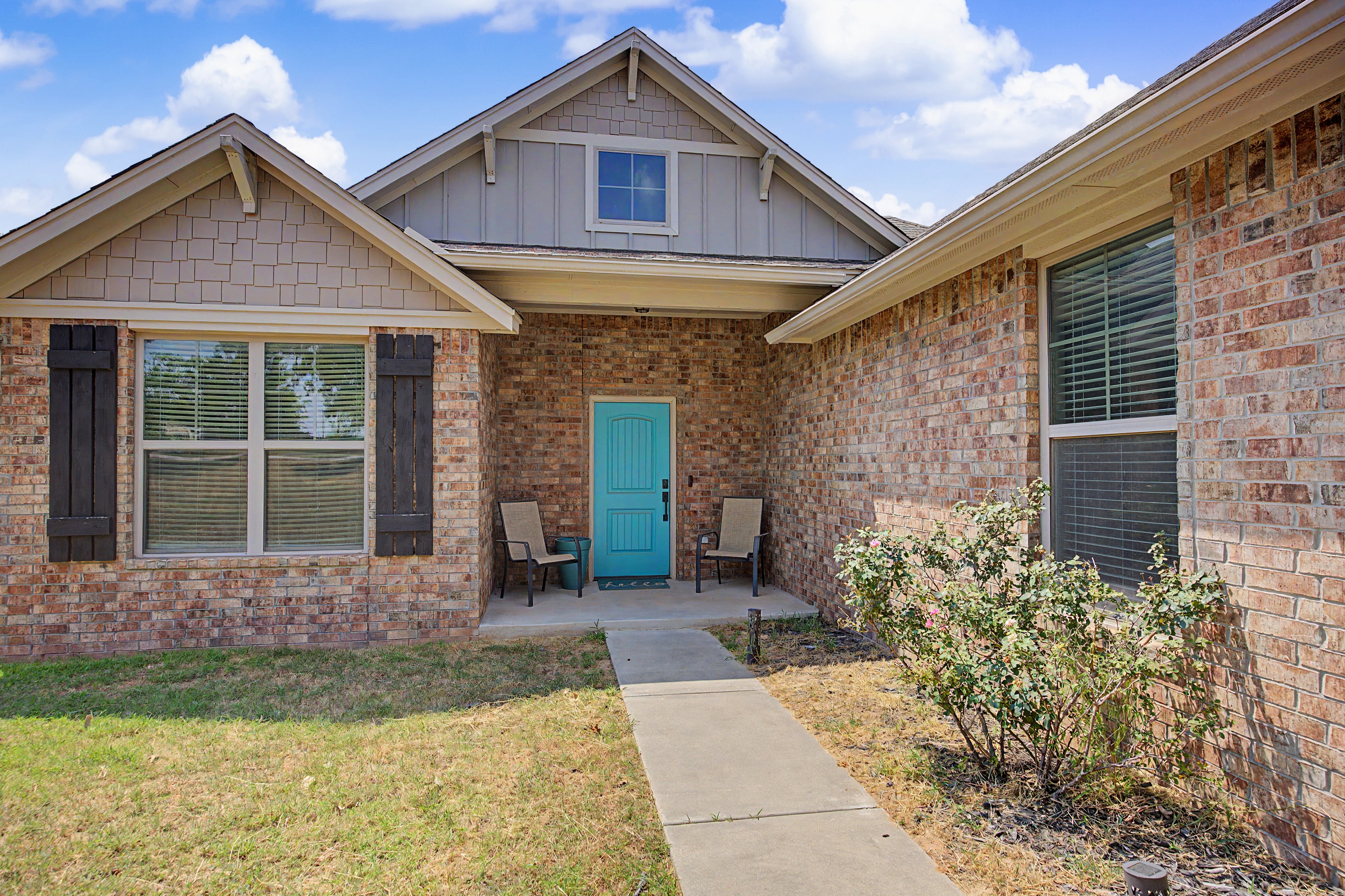 Brick home exterior with turquoise door at 14951 Remington Dr