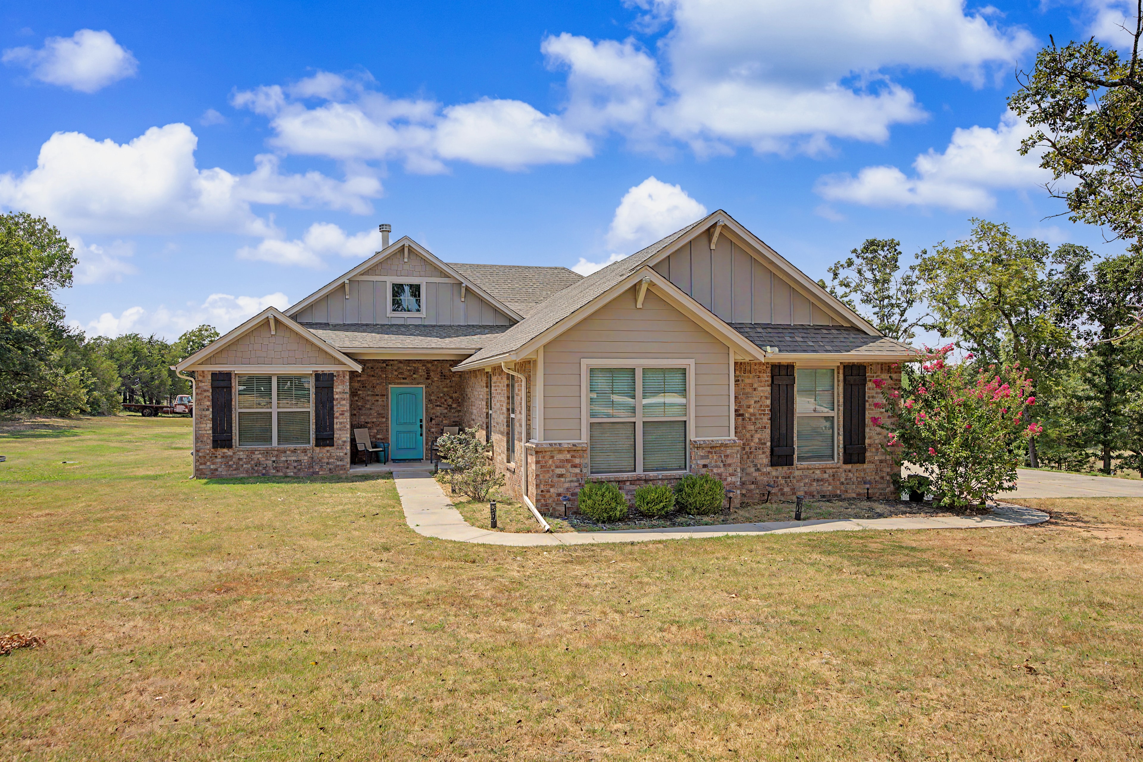 Brick and siding home exterior with turquoise door at 14951 Remington Dr