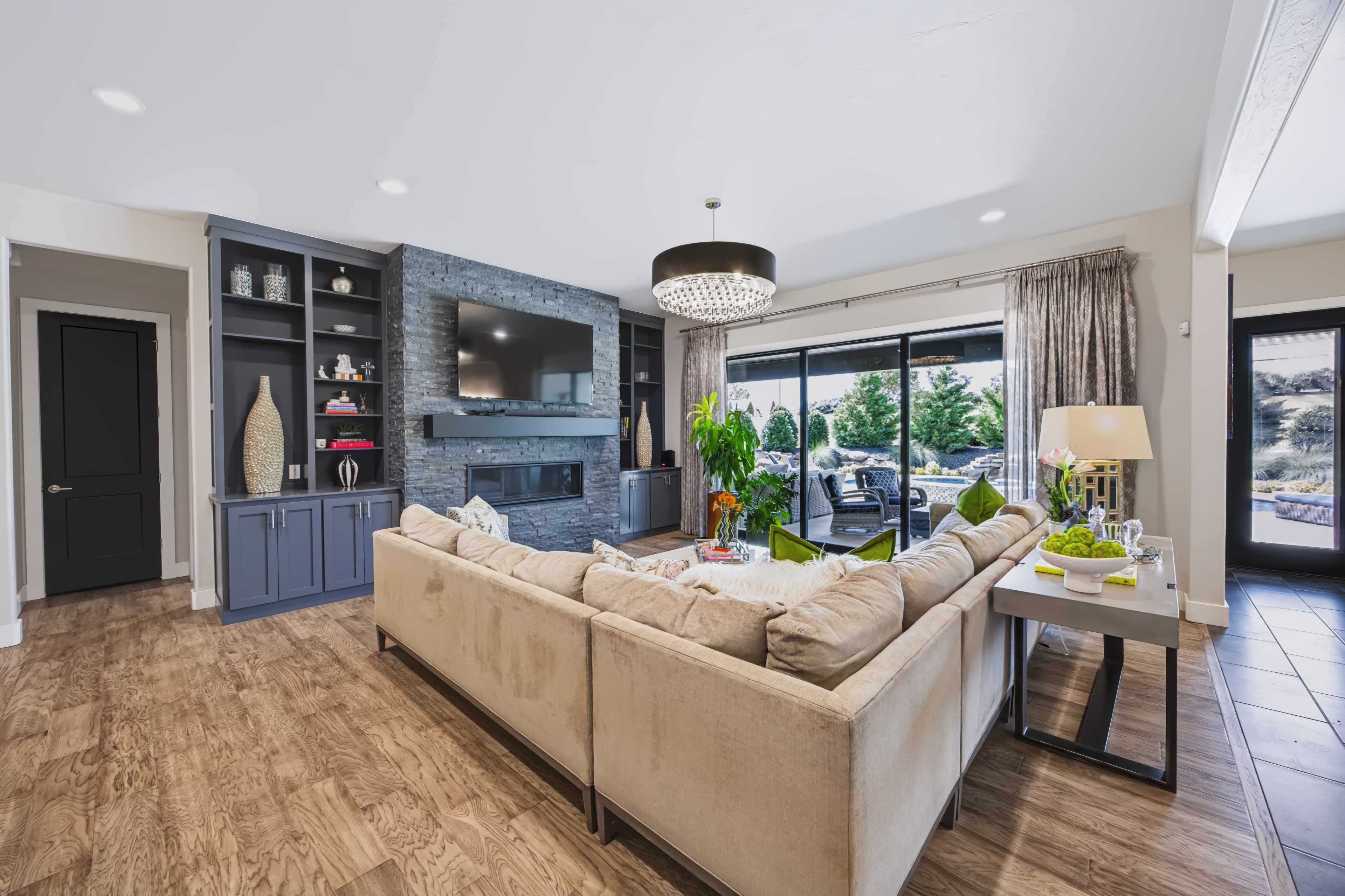 Living room with stone fireplace and built-in cabinetry at 21458 S Sawtooth Cir